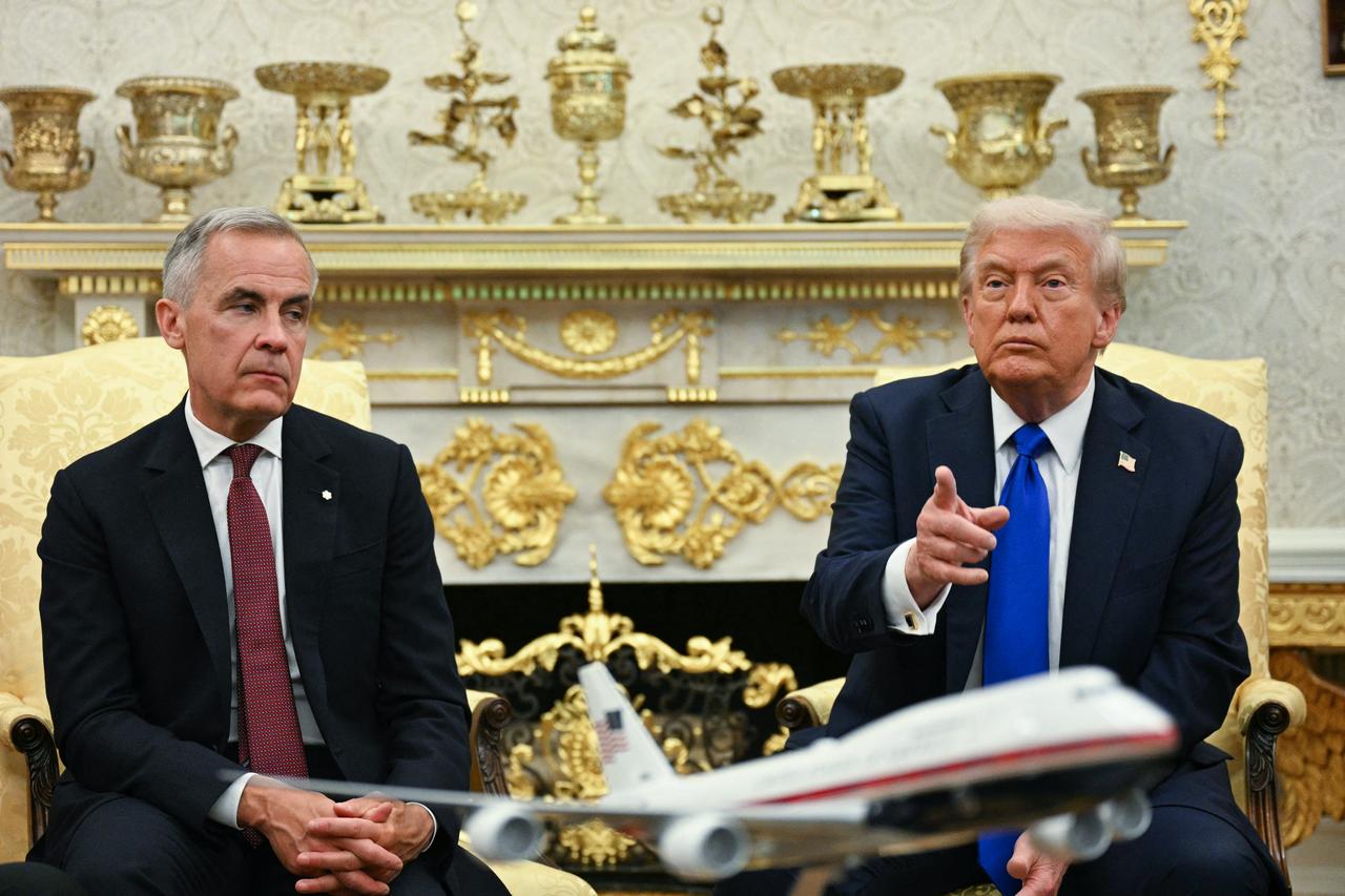 US President Donald Trump meets with Canadian Prime Minister Mark Carney in the Oval Office of the White House in Washington, DC, on October 7, 2025. (AFP)