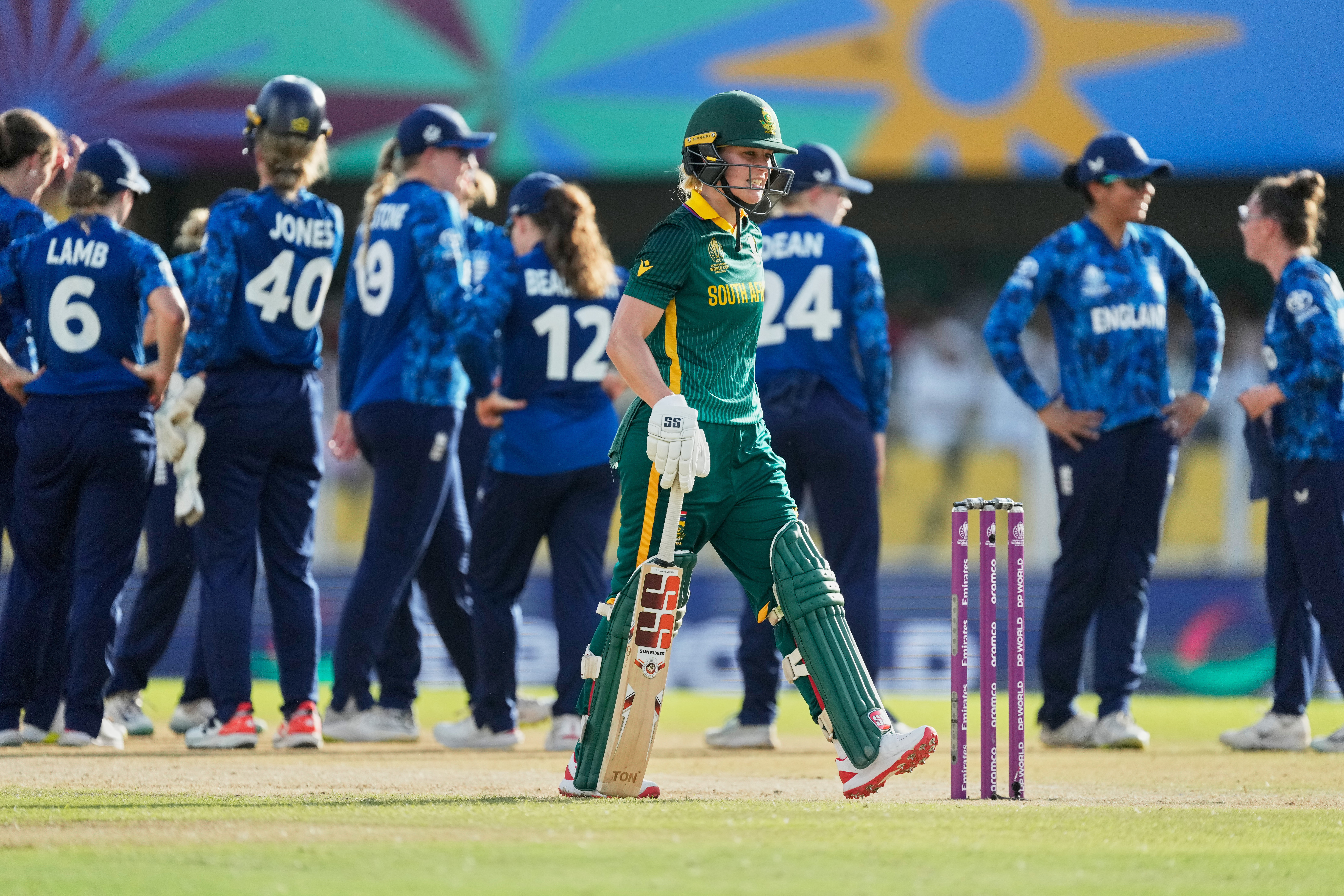 South Africa's Anneke Bosch walks off the field after losing her wicket as England's players celebrate during the ICC Women's Cricket World Cup match between England and South Africa in Guwahati, India, Tuesday, October 3, 2025. (AP)