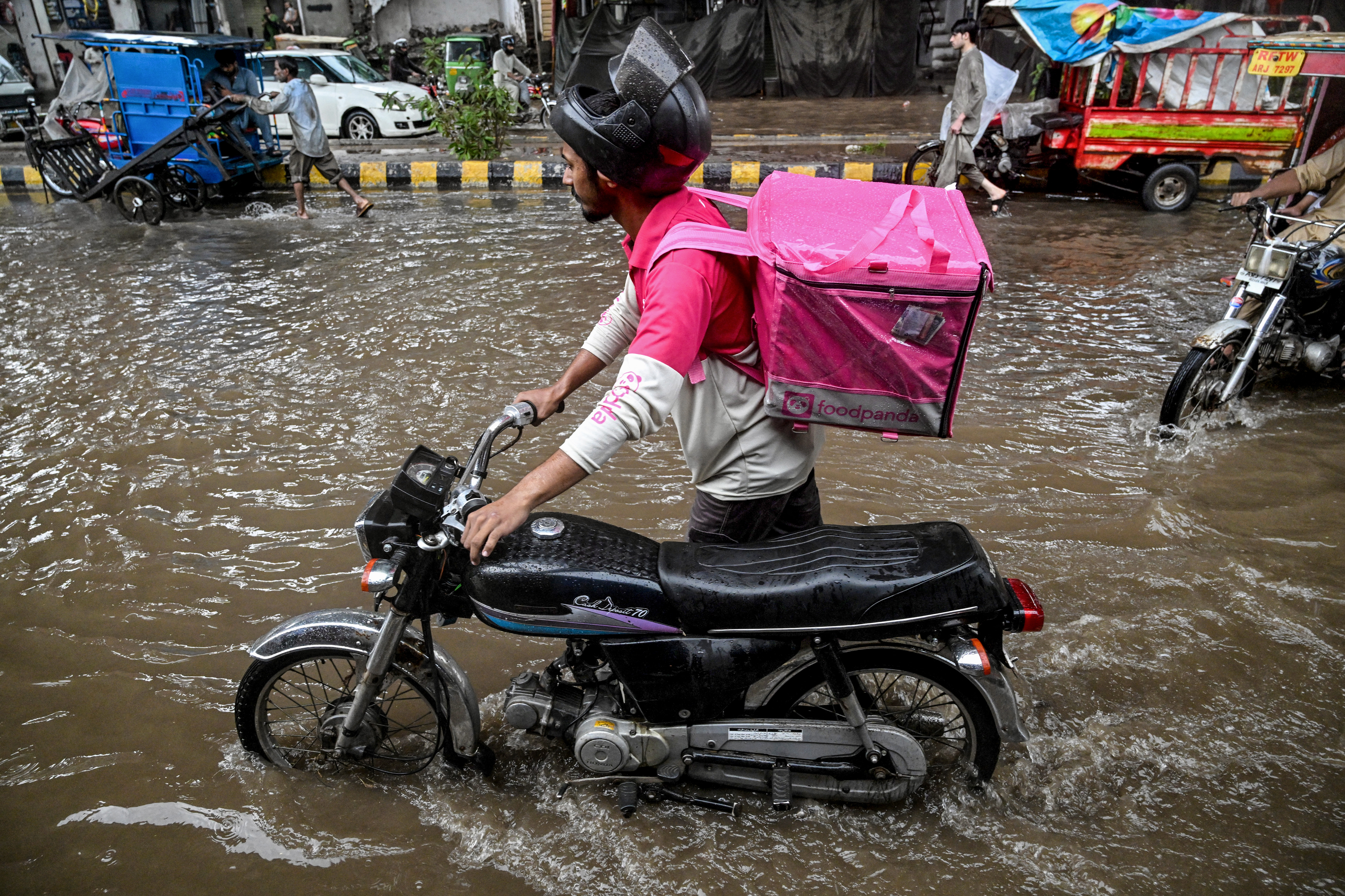 No pause for food delivery riders during Pakistan's monsoon