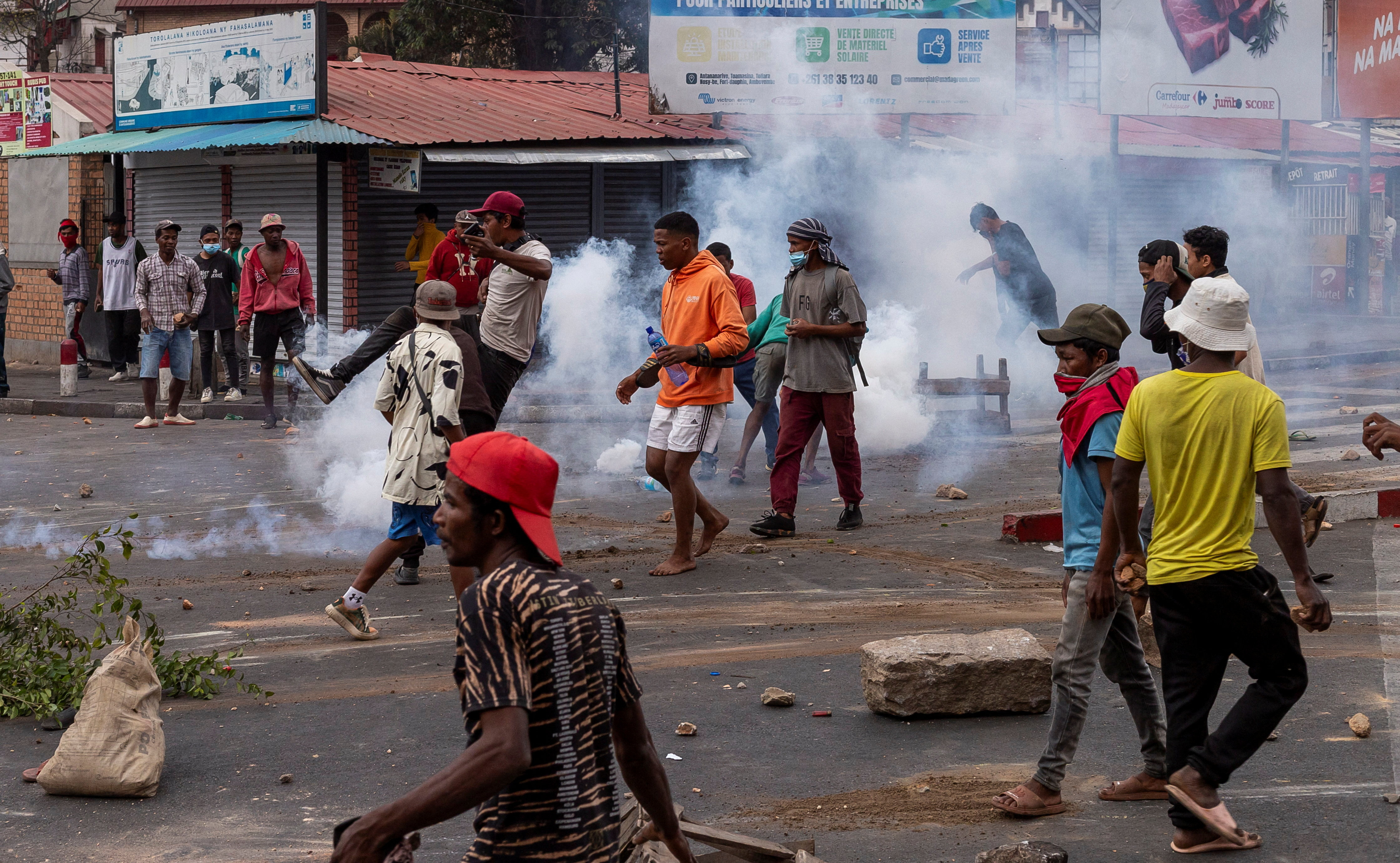 A protester kicks a tear gas canister lobbed by Malagasy riot police officers to disperse protesters during a demonstration against frequent power outages and water shortages, within Antaninandro neighborhood, in Antananarivo, Madagascar. (Reuters)