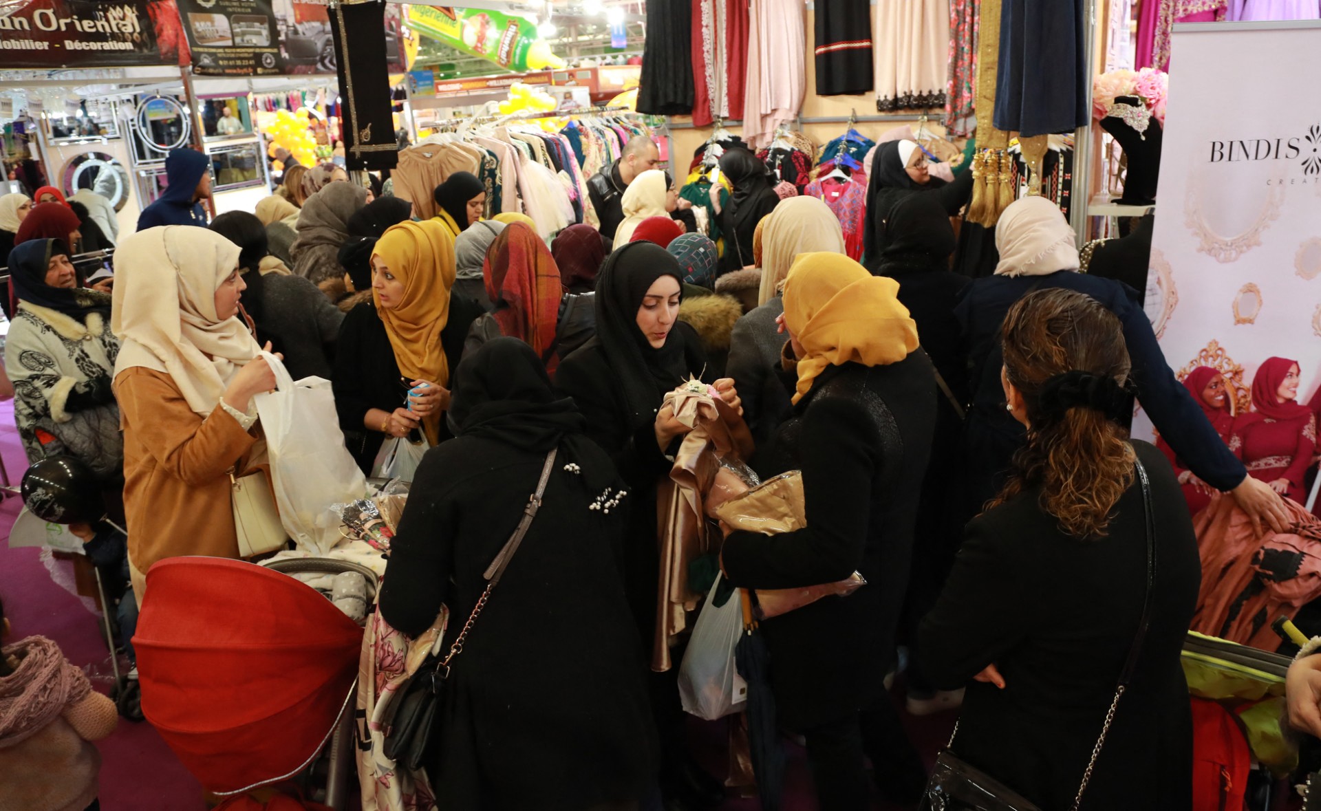 Women visit a booth selling clothing during the 35th annual meeting of the French Muslim community on March 30, 2018, at Le Bourget, north of Paris. (Photo by Jacques Demarthon / AFP)