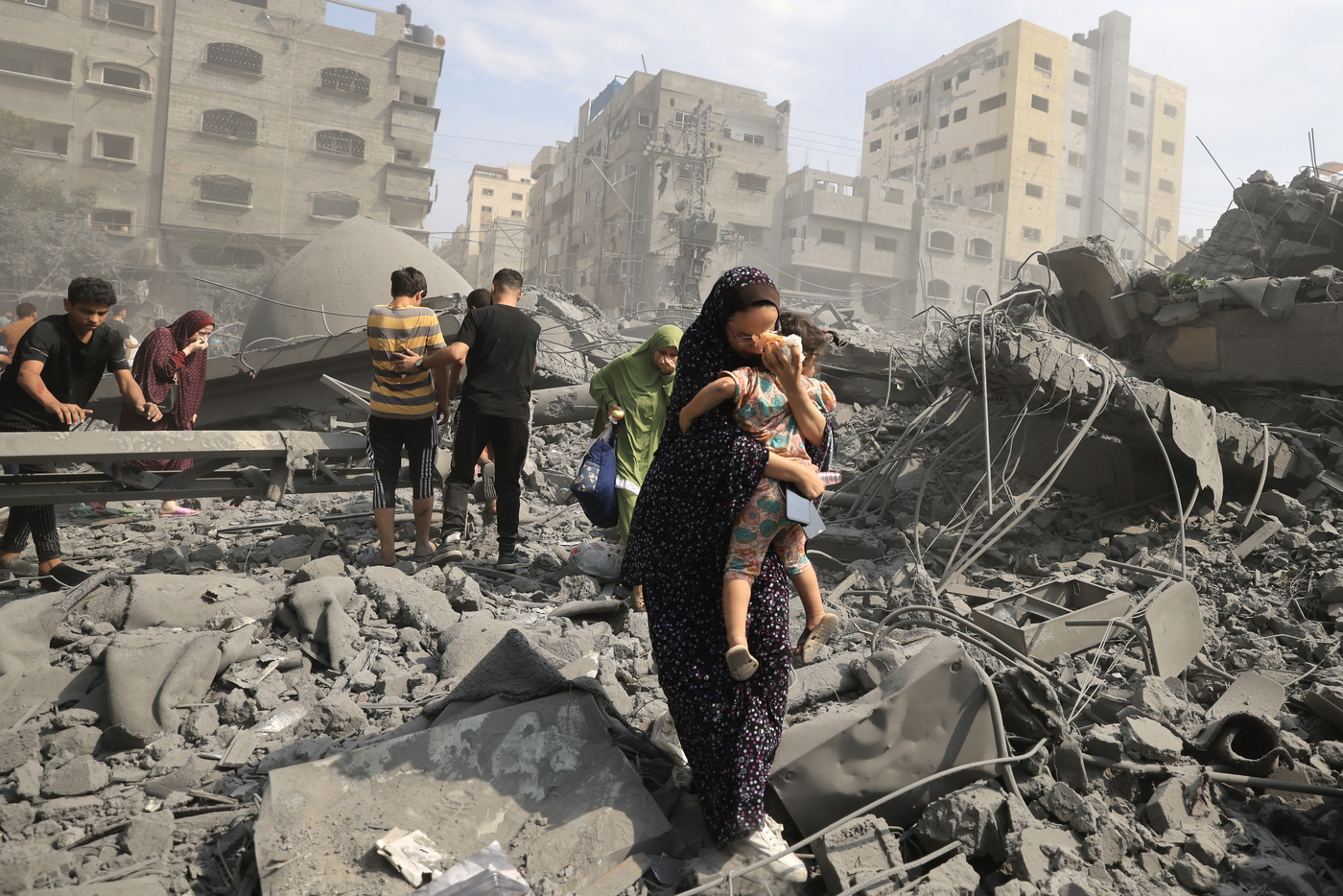 Palestinians in Gaza City inspect the damage following an Israeli airstrike, 9 October 2023, photo by Mahmud HAMS / AFP (Photo taken from OCHA)