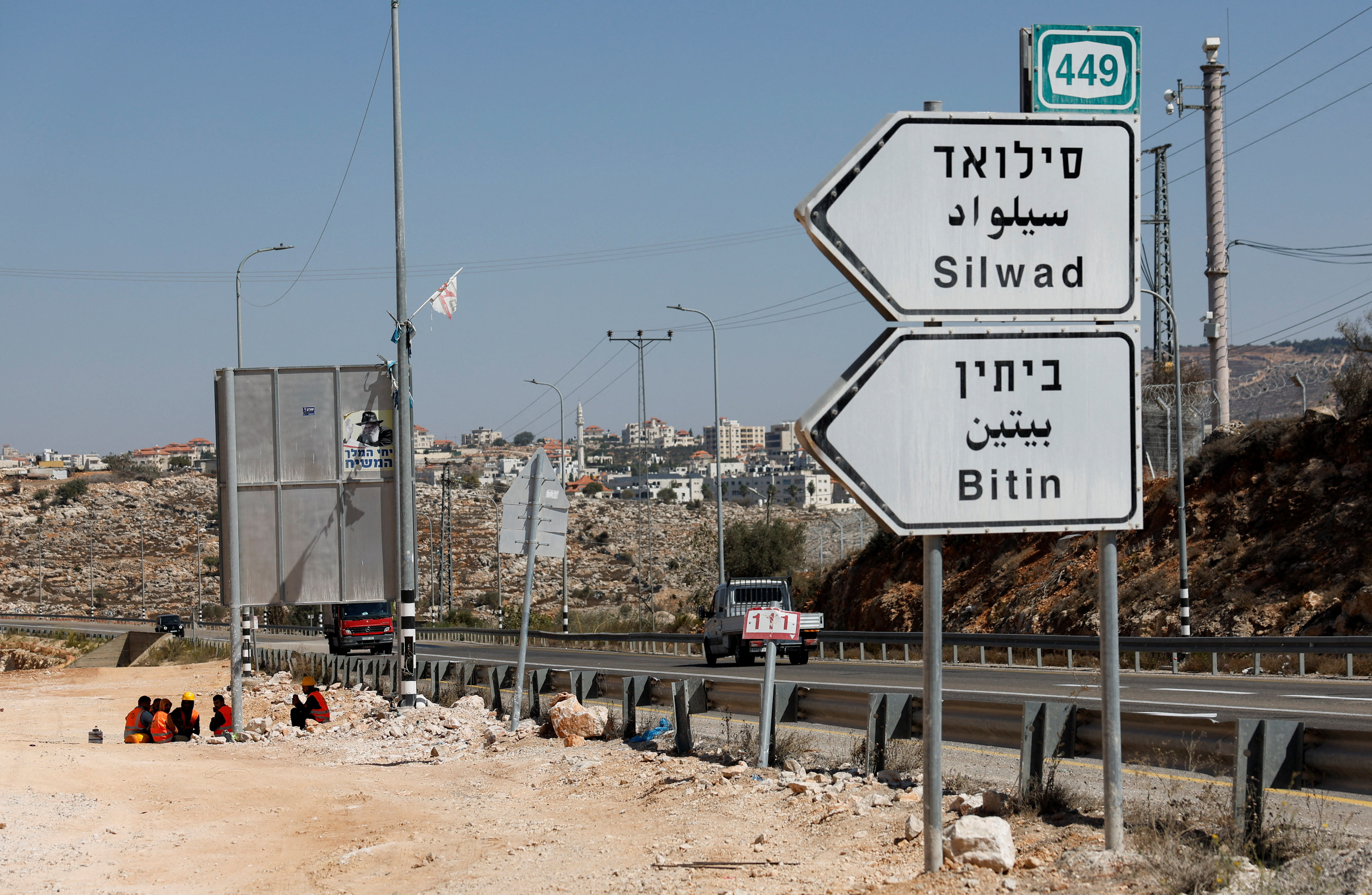 Workers eat during a break from expanding an Israeli bypass road connecting Israeli settlers in the West Bank with Jerusalem, near Ramallah in the Israeli-occupied West Bank, September 29, 2025. (Reuters)