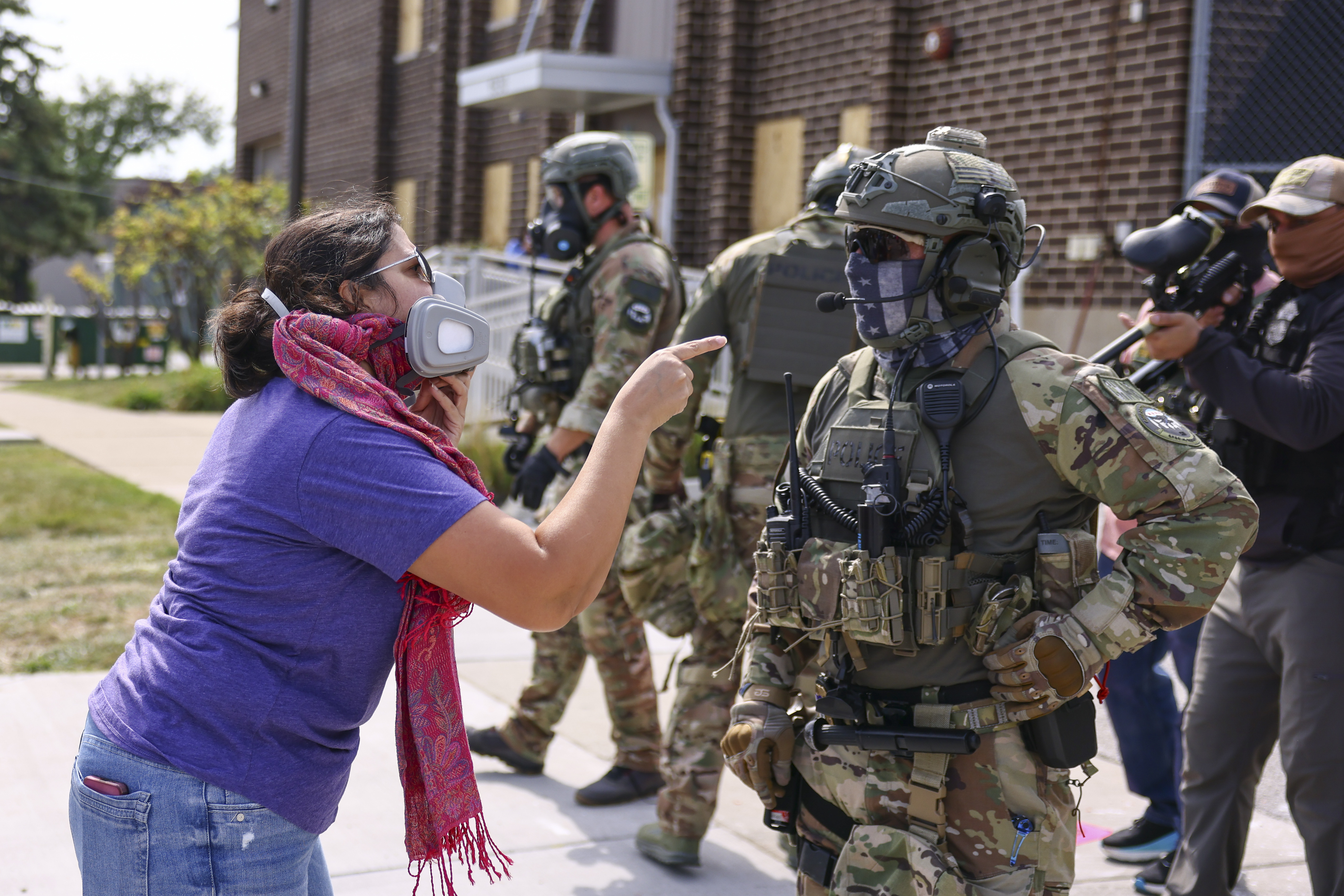 A protester confronts an Immigration and Customs Enforcement officer outside of an ICE facility in Broadview, Friday, Sept. 19, 2025. (Anthony Vazquez/Chicago Sun-Times via AP)