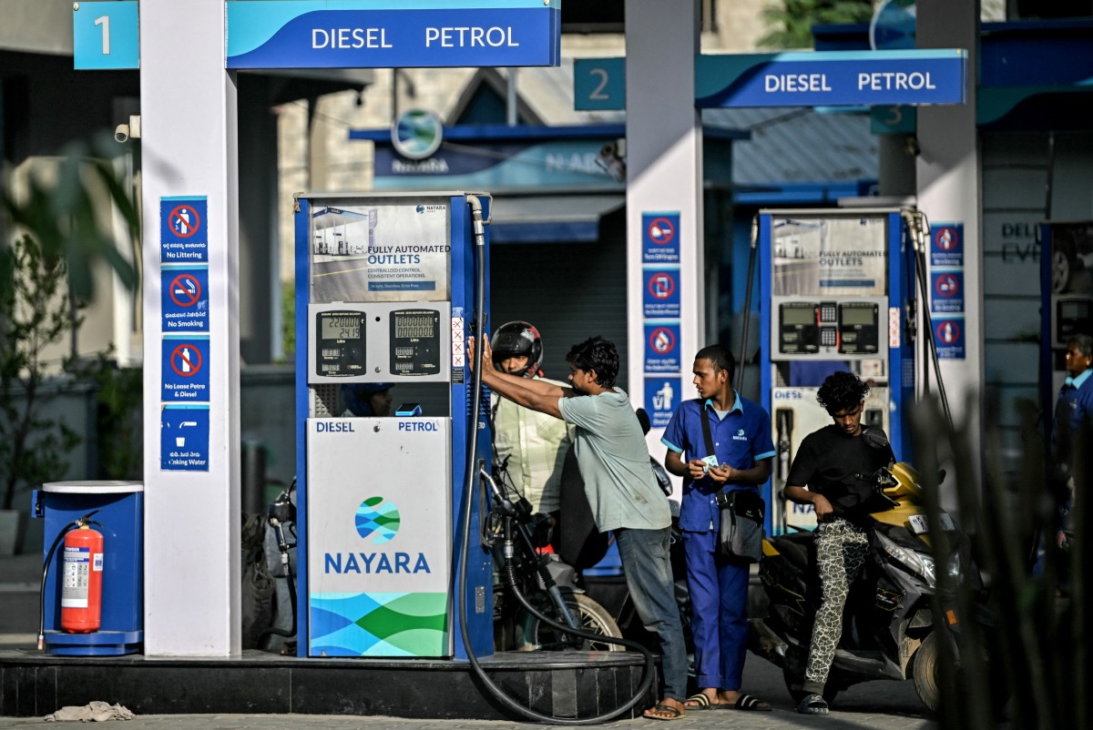 Customers refuel their vehicles at a gas station of Nayara Energy Limited, in Bengaluru on December 12, 2025. (AFP)