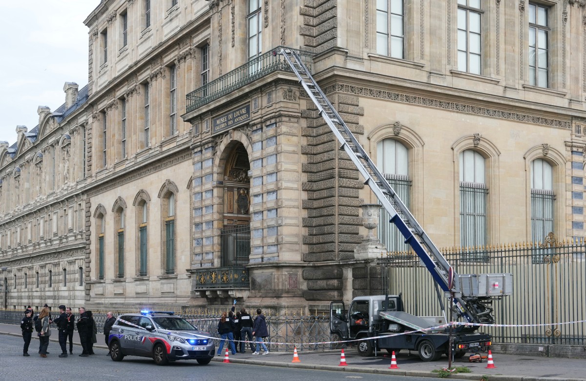 Woman charged over Louvre heist tears up in court