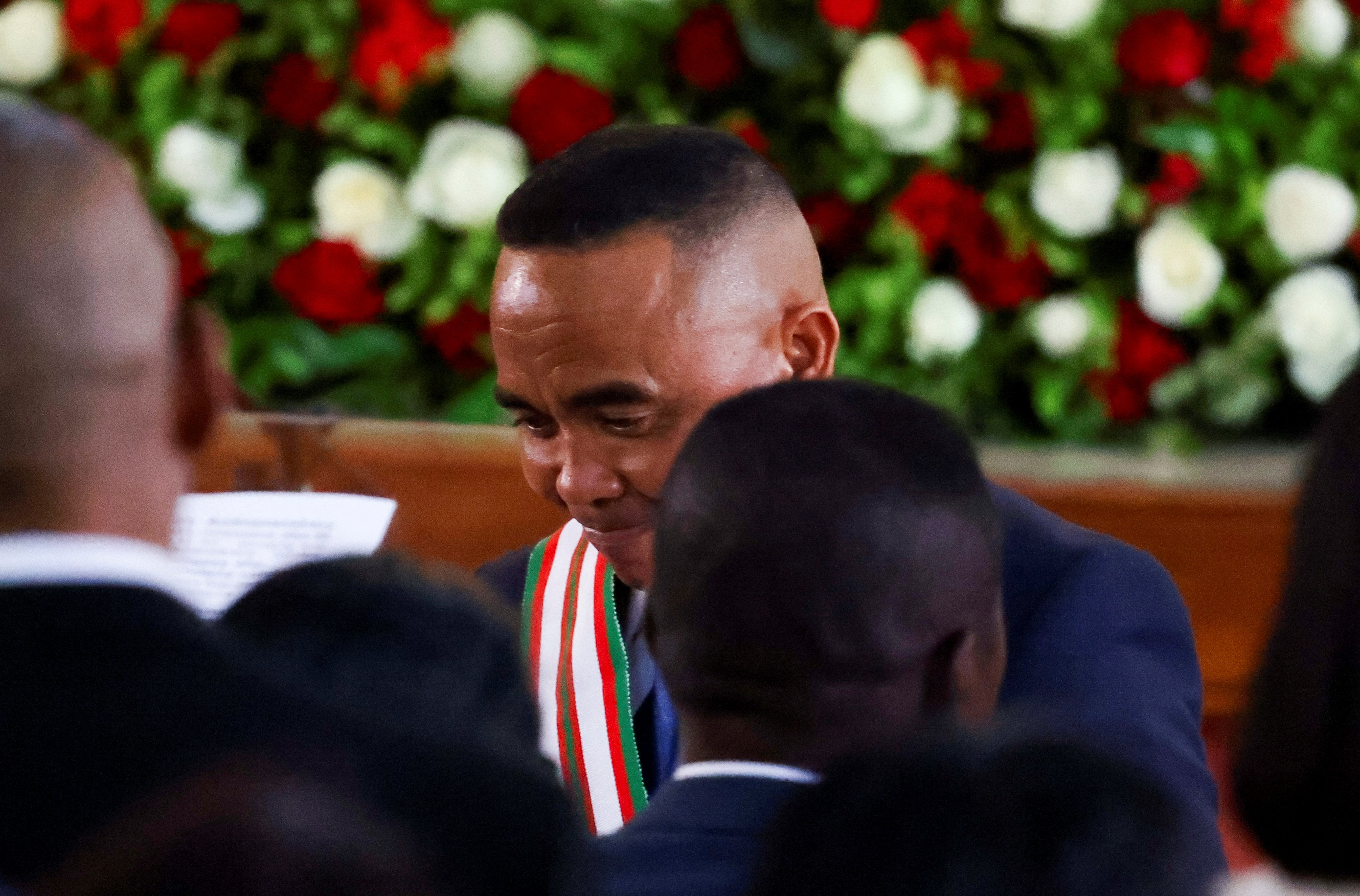 Madagascar's new military ruler, Colonel Michael Randrianirina, reacts as he takes a seat after being sworn in as president on Friday, taking over from Andry Rajoelina following a coup that ousted him, at the constitutional court in Antananarivo, Madagasc