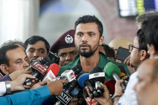 Bangladeshi cricket captain Mashrafe Bin Mortaza (C) talks to journalists upon his arrival with his teammates at Hazrat Shahjalal International Airport in Dhaka on July 7, 2019, after leaving the 2019 cricket World Cup. (AFP)