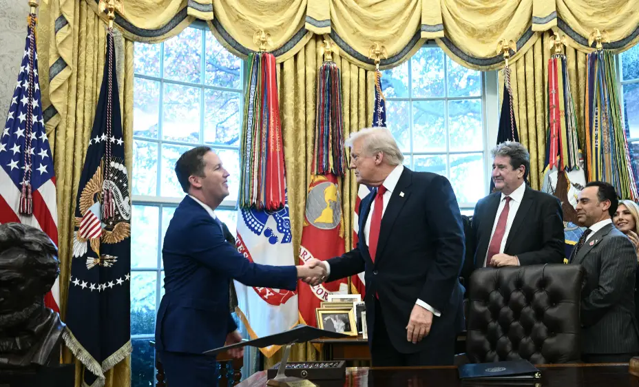 US President Donald Trump shakes hands with the newly appointed Ambassador to India Sergio Gor during a swearing-in ceremony in the Oval Office of the White on November 10, 2025 in Washington, DC. (Photo by Brendan SMIALOWSKI / AFP)