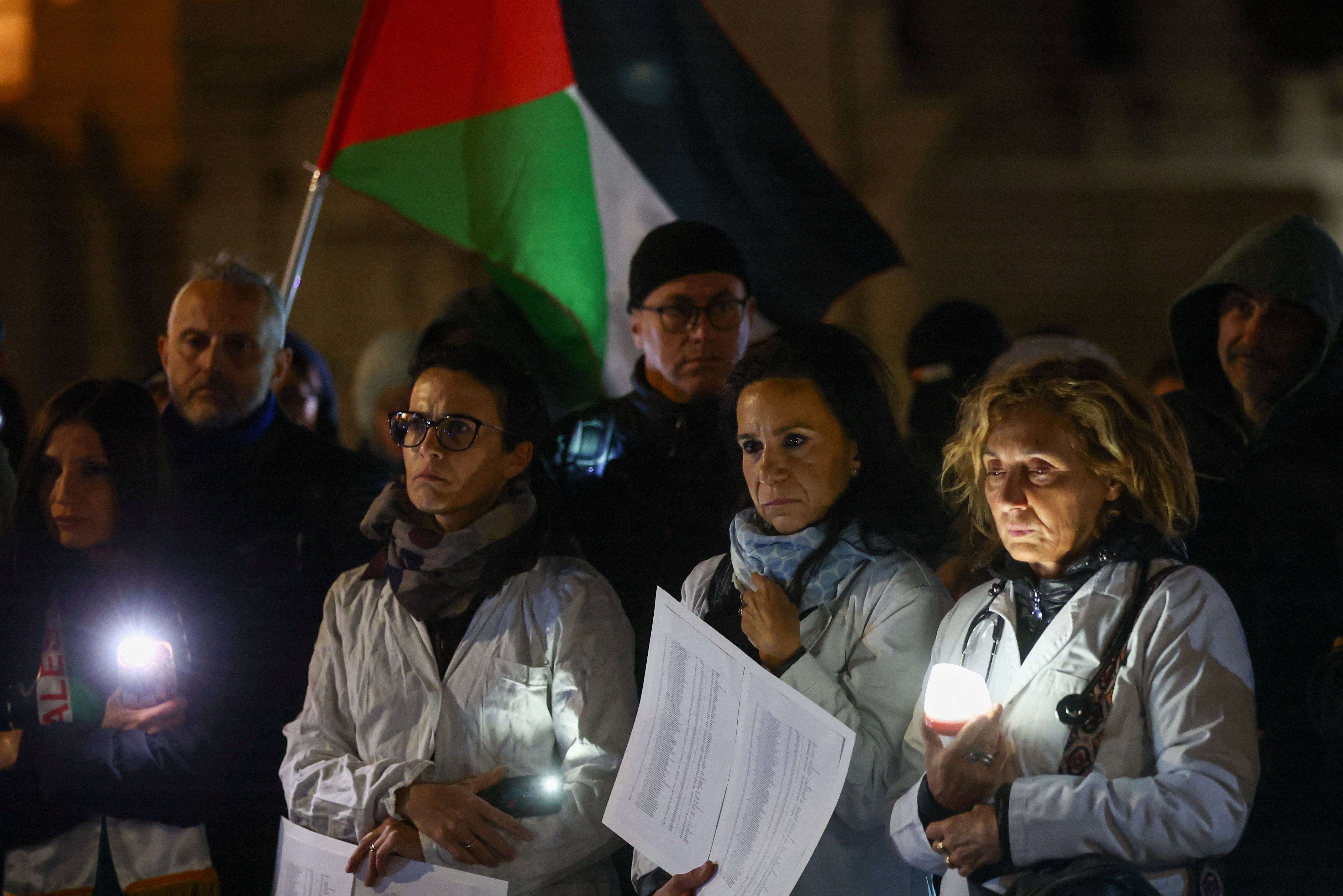 Healthcare workers take part in a pro-Palestinian vigil as part of the nationwide "Lights on Palestine" initiative, commemorating 1,677 Palestinian medical staff killed in Gaza over the past two years, in Rome, Italy October 2, 2025. (Reuters)