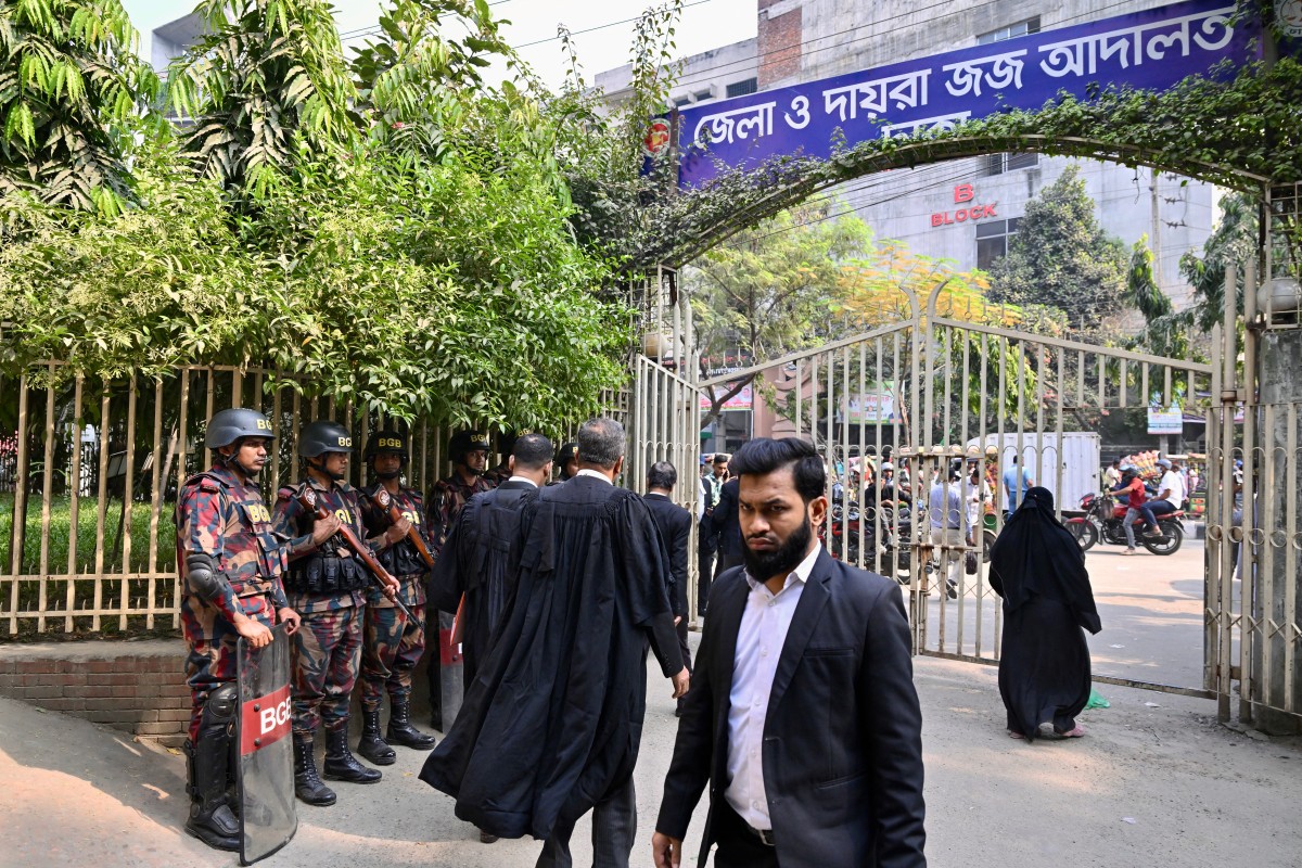 Border Guard Bangladesh (BGB) personnel stand guard outside a court in Dhaka on December 1, 2025 (AFP)
