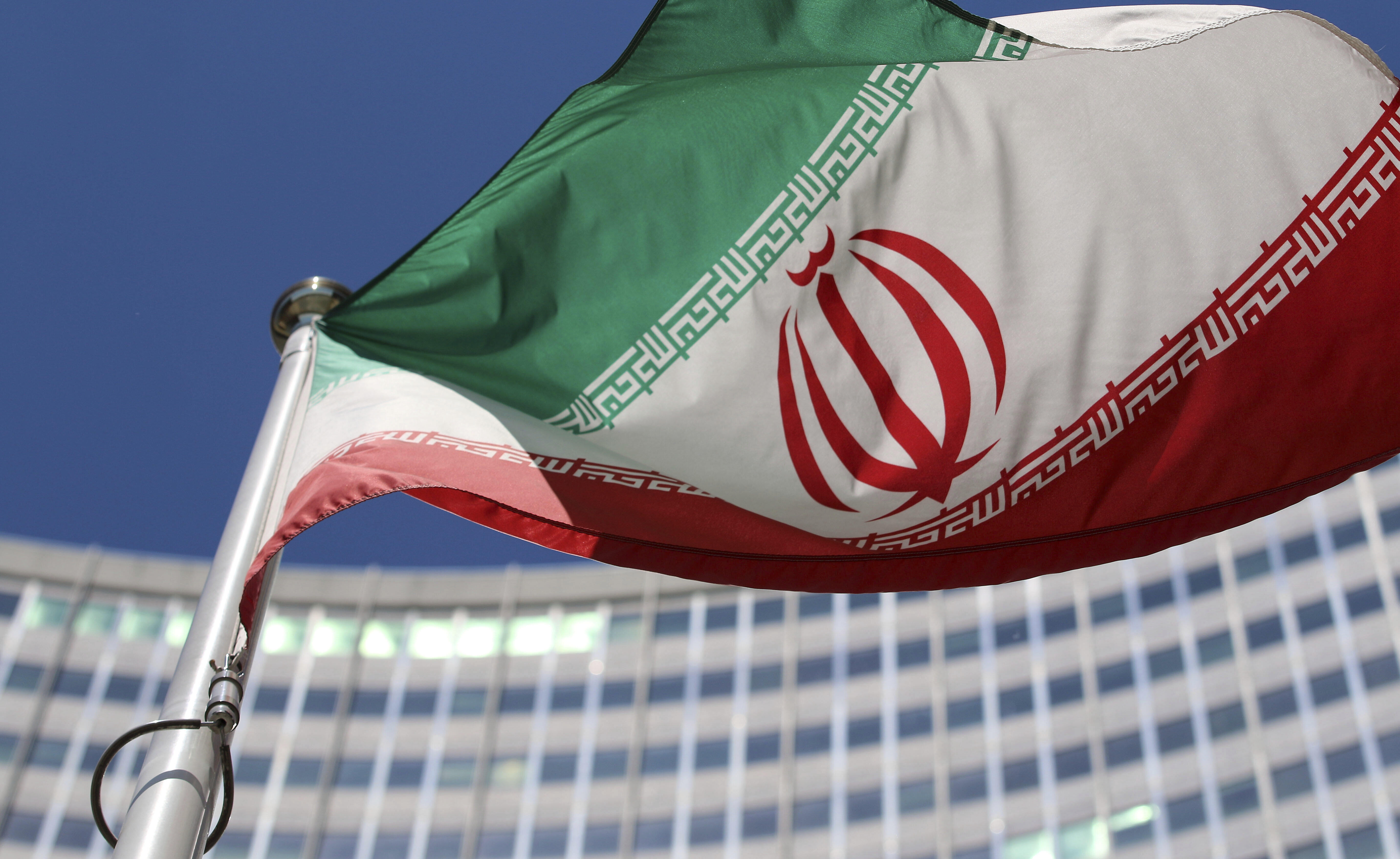 FILE - The Iranian flag flies in front of a U.N. building where closed-door nuclear talks take place at the International Center in Vienna, Austria, on June 18, 2014. 