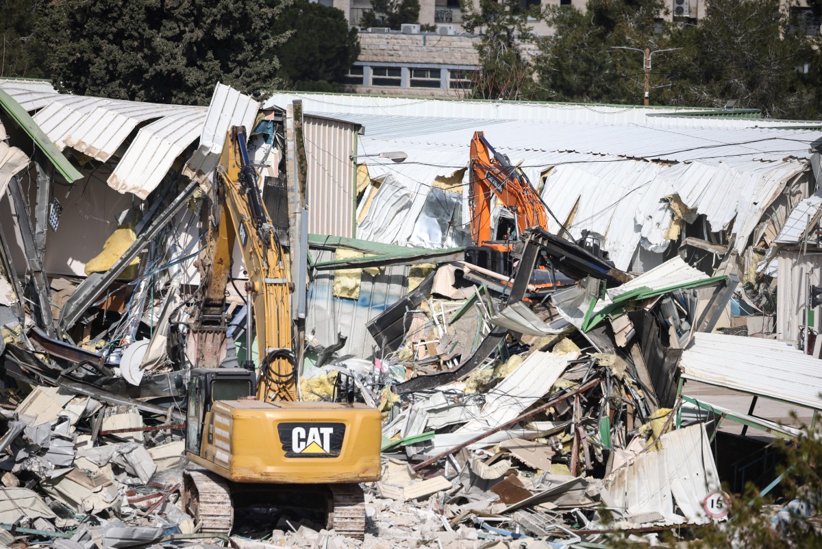 A photograph shows heavy machinery demolishing a structure inside the headquarters of the United Nations Relief and Works Agency (UNRWA) in the Sheikh Jarrah neighbourhood of Israeli-annexed east Jerusalem on January 20, 2026. (Photo by ILIA YEFIMOVICH / 