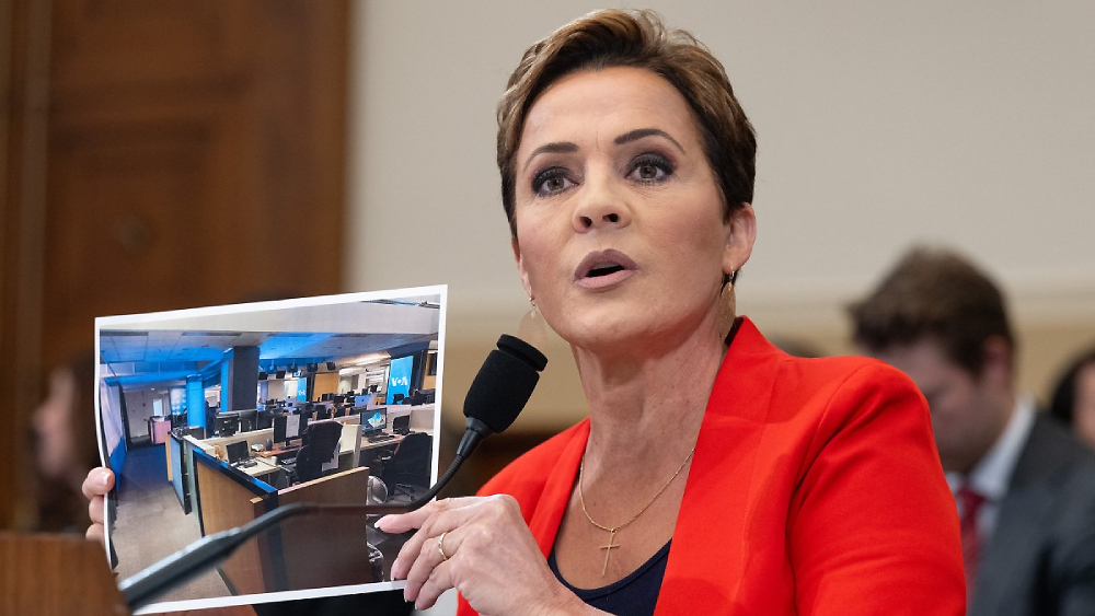 Kari Lake, Senior Advisor for US Agency for Global Media, holds up a photo of the Voice of America newsroom as she testifies during a House Foreign Affairs Committee hearing on the future of the US Agency for Global Media, on Capitol Hill in Washington, D