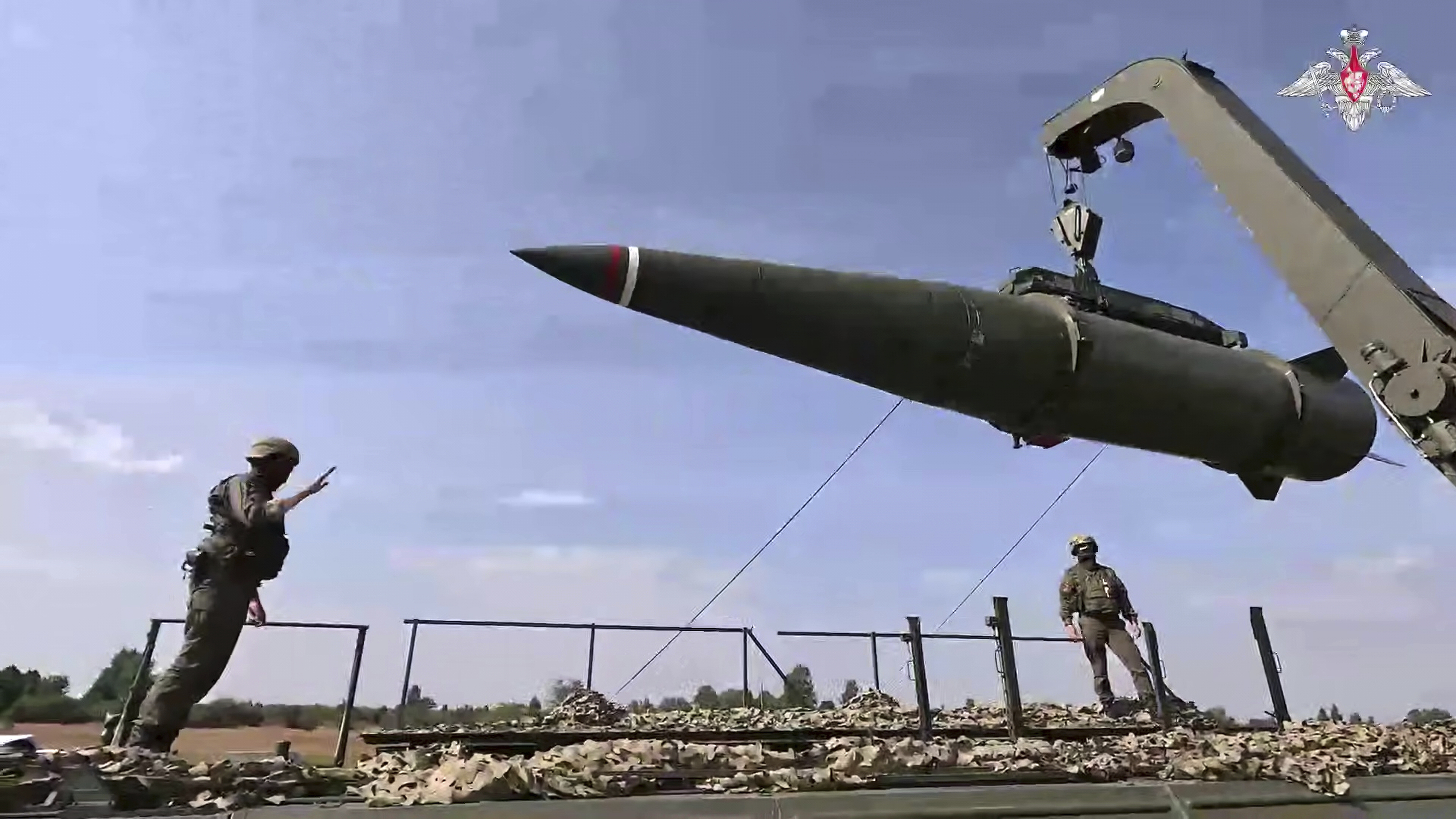 Russian troops load an Iskander missile 