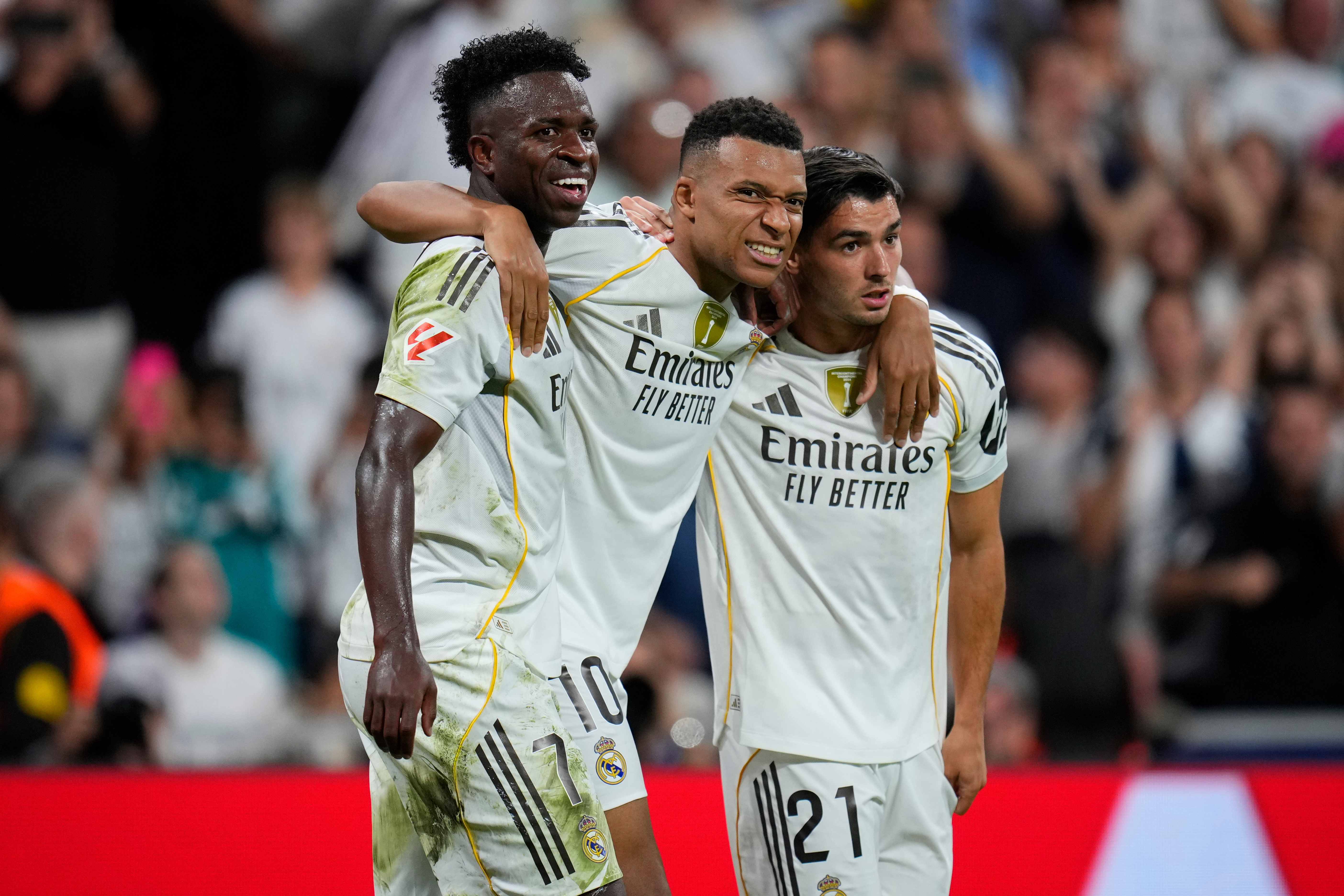 Real Madrid's Kylian Mbappe, centre, celebrates with Vinicius Junior, left, and Brahim Diaz after scoring his side's third goal during the Spanish La Liga soccer match between Real Madrid and Villarreal at the Santiago Bernabeu stadium in Madrid, Spain, S