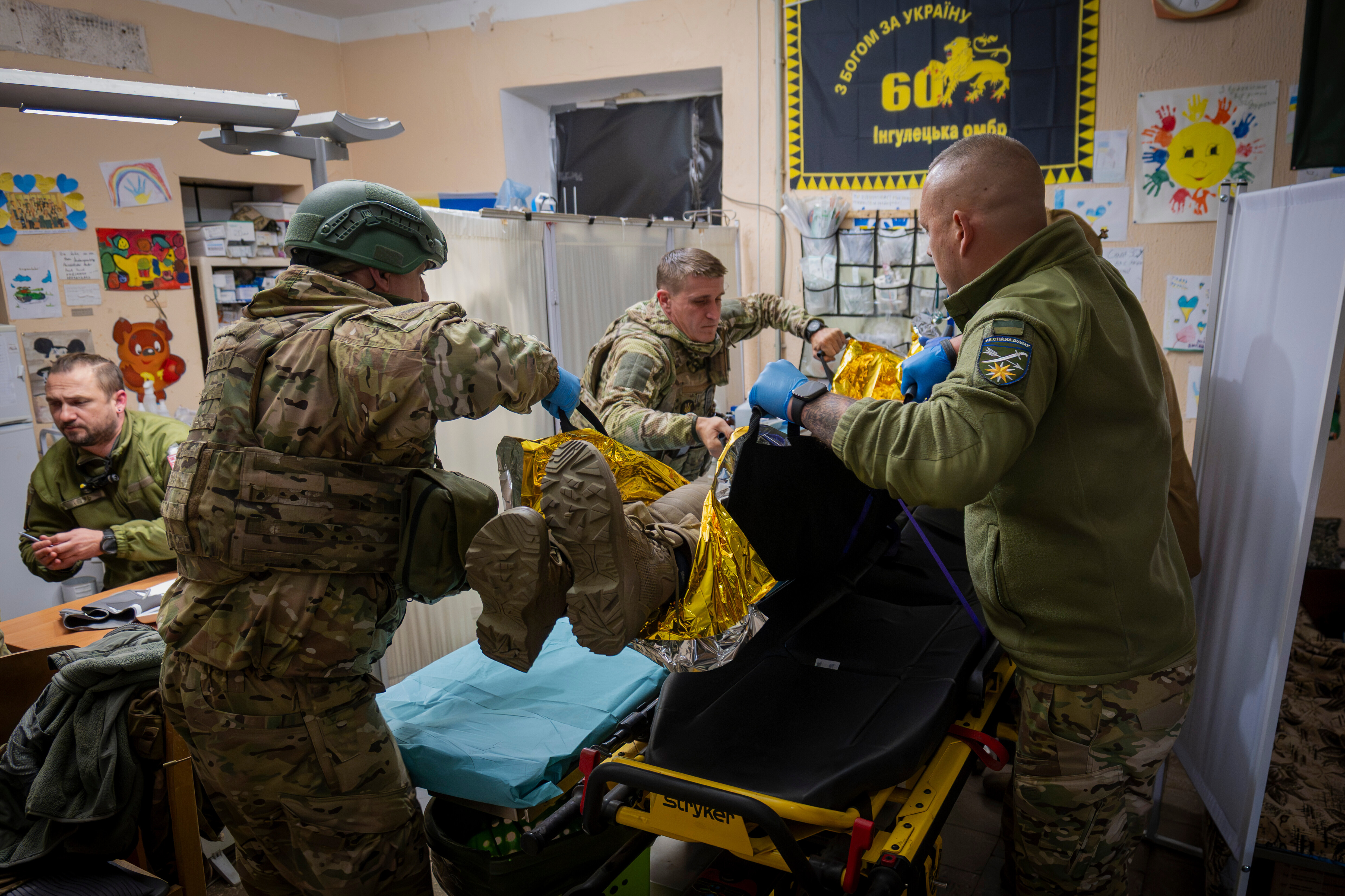 Military medics of the 66th Brigade give first aid to a wounded Ukrainian soldier at a medical stabilisation point in Donetsk region, Ukraine