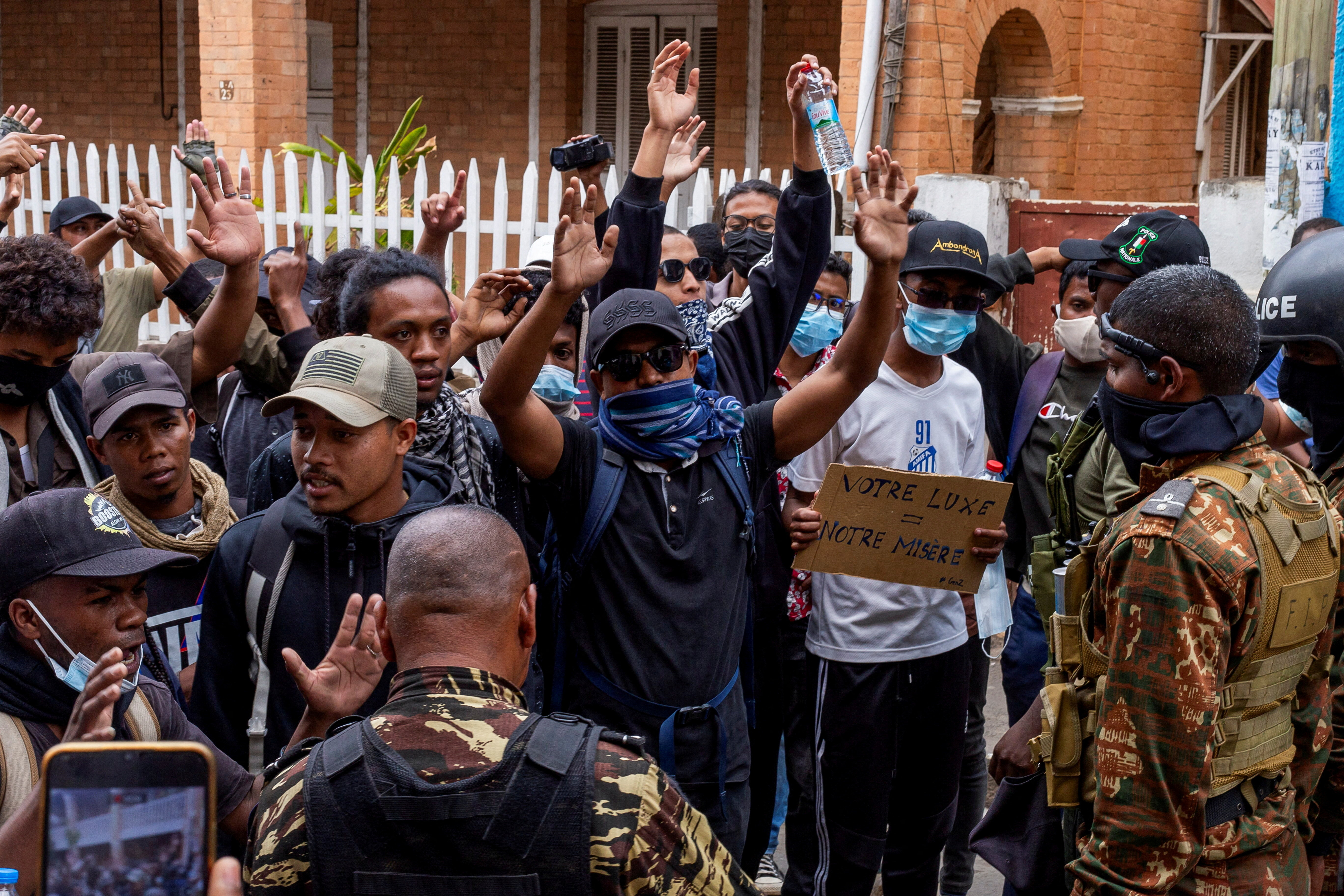 Protesters gesture in front of riot police officers during a demonstration against frequent power outages and water shortages, in the capital Antananarivo, Madagascar, October 1, 2025. (Reuters)
