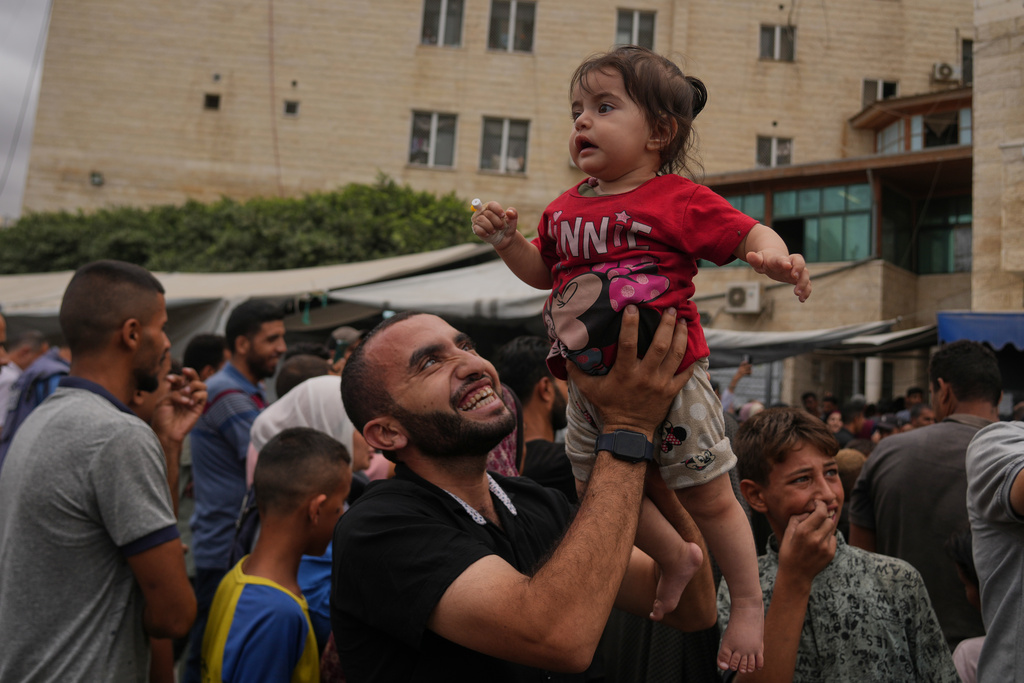 Palestinians celebrate following the announcement that Israel and Hamas have agreed to the first phase of a peace plan to pause the fighting, outside Al-Aqsa Hospital in Deir al-Balah, central Gaza Strip, Thursday, Oct. 9, 2025. (AP)