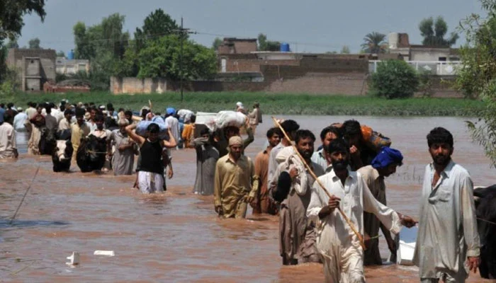 People evacuating from a flood-struck area. — AFP/File