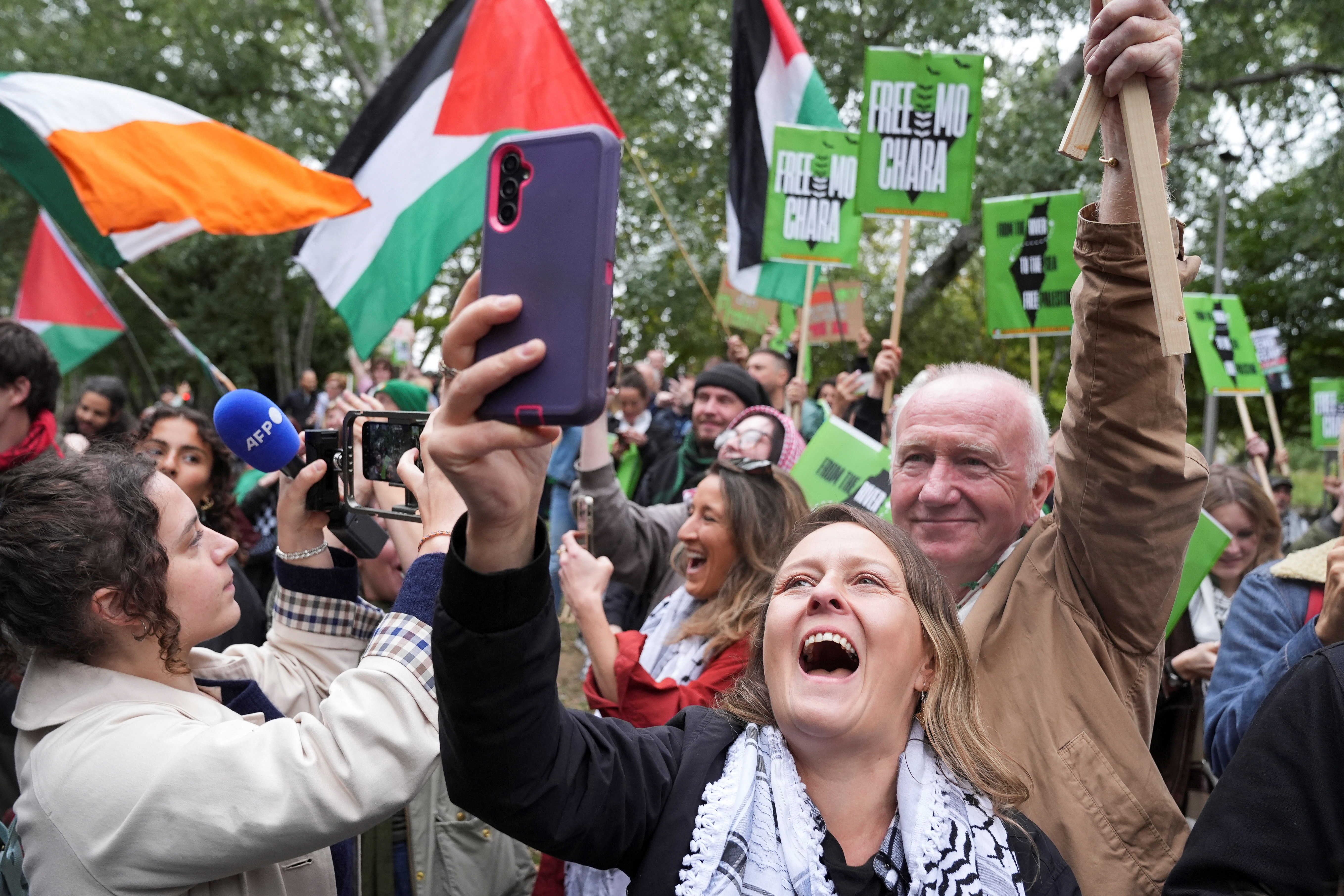 People celebrate outside the Woolwich Crown Court after its decision to throw out the prosecution of Kneecap member Liam O'Hanna charged with a terrorism offence in relation to the alleged display of a Hezbollah flag onstage in 2024, in London. (Reuters)